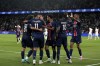 PSG's Marco Asensio, back to camera, celebrates with teammates after scoring his side's second goal during the French League 1 soccer match between Paris Saint-Germain and Montpellier at the Parc des Princes in Paris, Friday, Aug. 23, 2024. (AP Photo/Thibault Camus)