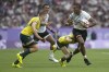 Fiji's Joseva Talacolo, right looks to fend off an incoming tackle form Australia's Nick Malouf left, during the men's semifinal Rugby Sevens match between Fiji and Australia at the 2024 Summer Olympics, in the Stade de France, in Saint-Denis, France, Saturday, July 27, 2024. (AP Photo/Tsvangirayi Mukwazhi)