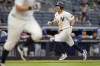 New York Yankees' Anthony Volpe, right, reacts as he scores on a single hit by DJ LeMahieu during the 10th inning of a baseball game against the Toronto Blue Jays at Yankee Stadium, Sunday, Aug. 4, 2024, in New York. (AP Photo/Seth Wenig)