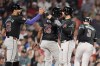 Arizona Diamondbacks' Eugenio Suárez, third from left, celebrates after his grand slam that also drove in Lourdes Gurriel Jr. (12), Josh Bell (36) and Joc Pederson (3) during the seventh inning of a baseball game against the Boston Red Sox, Friday, Aug. 23, 2024, in Boston. (AP Photo/Michael Dwyer)