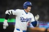 Los Angeles Dodgers designated hitter Shohei Ohtani (17) singles during the fourth inning of a baseball game against the Tampa Bay Rays in Los Angeles, Friday, Aug. 23, 2024. (AP Photo/Ashley Landis)