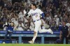 Los Angeles Dodgers designated hitter Shohei Ohtani (17) runs the bases after hitting a grand slam during the ninth inning of a baseball game against the Tampa Bay Rays in Los Angeles, Friday, Aug. 23, 2024. The Dodgers won 7-3. Will Smith, Tommy Edman, and Max Muncy also scored. (AP Photo/Ashley Landis)
