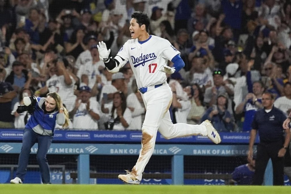 Los Angeles Dodgers designated hitter Shohei Ohtani (17) runs the bases after hitting a grand slam during the ninth inning of a baseball game against the Tampa Bay Rays in Los Angeles, Friday, Aug. 23, 2024. The Dodgers won 7-3. Will Smith, Tommy Edman, and Max Muncy also scored. (AP Photo/Ashley Landis)