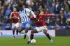 Brighton & Hove Albion's Carlos Baleba, left, and Manchester United's Kobbie Mainoo battle for the ball during the English Premier League soccer match between Brighton & Hove Albion and Manchester United at the American Express Stadium, Brighton, England, Saturday Aug. 24, 2024. (Gareth Fuller/PA via AP)