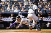 Colorado Rockies' Jake Cave (11) dives to score a run during the third inning of a baseball game against the New York Yankees, Saturday, Aug. 24, 2024, in New York. (AP Photo/Eduardo Munoz Alvarez)