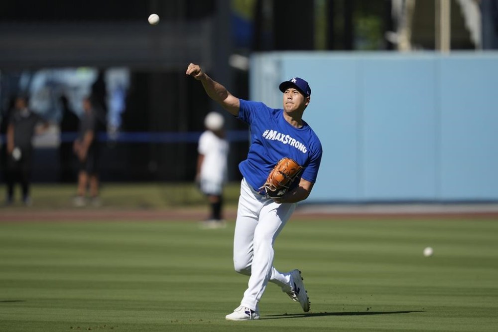 Los Angeles Dodgers designated hitter Shohei Ohtani works out before a baseball game against the Tampa Bay Rays in Los Angeles, Saturday, Aug. 24, 2024. (AP Photo/Ashley Landis)