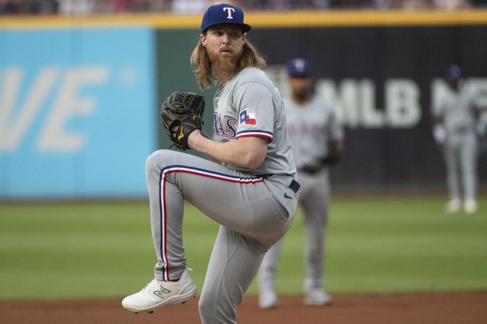 Texas Rangers starting pitcher Jon Gray delivers against the Cleveland Guardians during the first inning of a baseball game in Cleveland, Saturday, Aug. 24, 2024. (AP Photo/Phil Long)