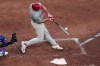 Philadelphia Phillies' J.T. Realmuto hits a three-run home run during the sixth inning of a baseball game against the Kansas City Royals Saturday, Aug. 24, 2024, in Kansas City, Mo. (AP Photo/Charlie Riedel)