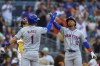 New York Mets' Francisco Lindor (12) celebrates with Jeff McNeil (1) after hitting a grand slam during the fourth inning of a baseball game against the San Diego Padres, Saturday, Aug. 24, 2024, in San Diego. (AP Photo/Brandon Sloter)