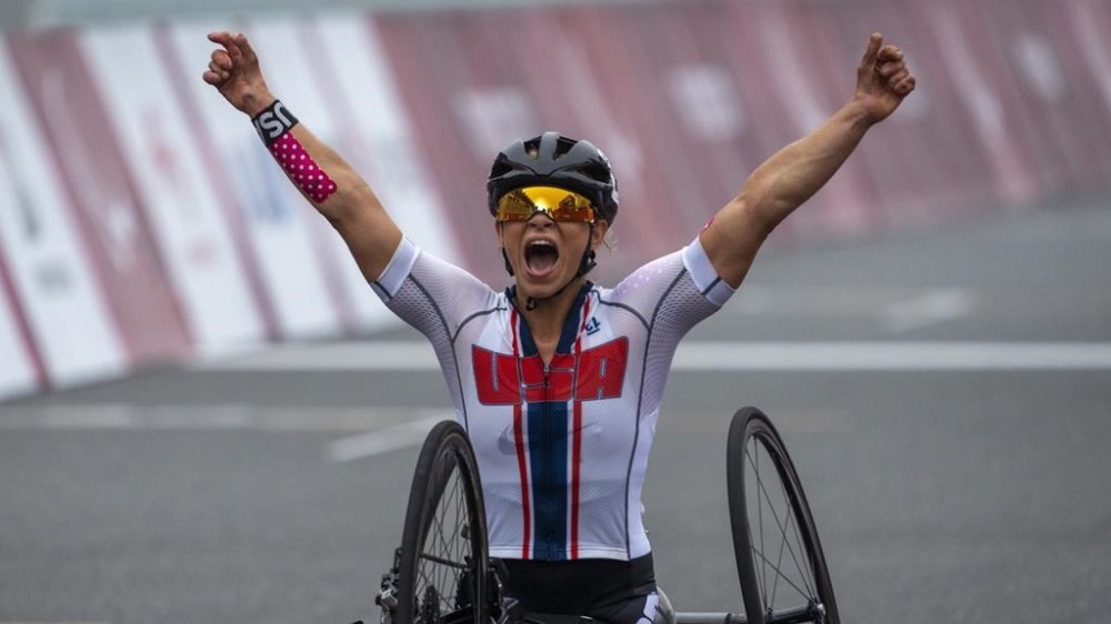 FILE - Oksana Masters, of the United States, celebrates after winning at Women's H5 Road Race at the Fuji International Speedway at the Tokyo 2020 Paralympic Games, Sept. 1, 2021, in Tokyo, Japan. Paralympians are not participating. They are competing. A number of athletes preparing for the Paris 2024 Paralympic Games proclaimed that message on their social feeds over the past few days, reminding the world that Olympians are not the only athletes coming to Paris looking for gold. (AP Photo/Emilio Morenatti, File)