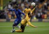Chelsea's Noni Madueke, left, and Wolverhampton Wanderers' Matheus Cunha battle for the ball during the English Premier League soccer match between Wolverhampton Wanderers and Chelsea at Molineux Stadium, Wolverhampton, England. Sunday Aug. 25, 2024. (Joe Giddens/PA via AP)