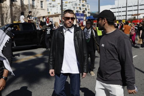 FILE - U.S. rapper Macklemore, center, attends a demonstration in support of Palestinians calling for a cease-fire in the Gaza Strip, near the Dolby Theatre where the 96th Academy Awards Oscars ceremony is held, Sunday, March 10, 2024, in the Hollywood section of Los Angeles. (AP Photo/Etienne Laurent, File)