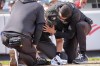 Medical staff tend to umpire Nick Mahrley, center, after he was hit by a bat during the fifth inning of a baseball game between the Colorado Rockies and the New York Yankees, Sunday, Aug. 25, 2024, in New York. (AP Photo/Bryan Woolston)