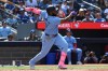 Toronto Blue Jays first baseman Vladimir Guerrero Jr. (27) hits an RBI double against the Los Angeles Angels, scoring George Springer, during fifth inning MLB baseball action in Toronto on Sunday, Aug 25, 2024. THE CANADIAN PRESS/Jon Blacker
