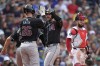 Arizona Diamondbacks' Eugenio Suárez, center, celebrates after his three-run home run with Pavin Smith, left, near Boston Red Sox catcher Connor Wong, right, in the sixth inning of a baseball game, Sunday, Aug. 25, 2024, in Boston. (AP Photo/Steven Senne)