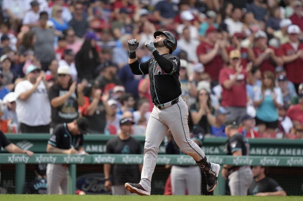 Arizona Diamondbacks' Eugenio Suárez celebrates as he runs the bases toward home after hitting a three-run home run in the sixth inning of a baseball game against the Boston Red Sox, Sunday, Aug. 25, 2024, in Boston. (AP Photo/Steven Senne)