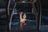 Paralympic swimmer Ali Truwit holds onto a starting platform while posing for photos, following practice at Chelsea Piers Athletic Club, Friday, Aug. 2, 2024, in Stamford, Conn. (AP Photo/Julia Nikhinson)