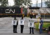 The shutdown at Canada's two major railways last week was not the first time a simultaneous work stoppage has brought trains to a halt. Locked-out Canadian National Rail workers stand at a picket line as locomotives are moved by management at CN Rail's Thornton Yard, in Surrey, B.C., Thursday, Aug. 22, 2024. THE CANADIAN PRESS/Darryl Dyck
