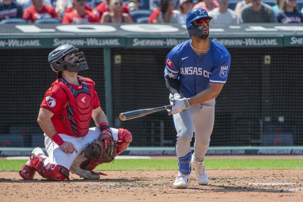 Kansas City Royals' MJ Melendez, right, watches his three-run home run off Cleveland Guardians relief pitcher Eli Morgan along with Austin Hedges, left, during the fourth inning of the first game of a baseball doubleheader in Cleveland, Monday, Aug. 26, 2024. (AP Photo/Phil Long)