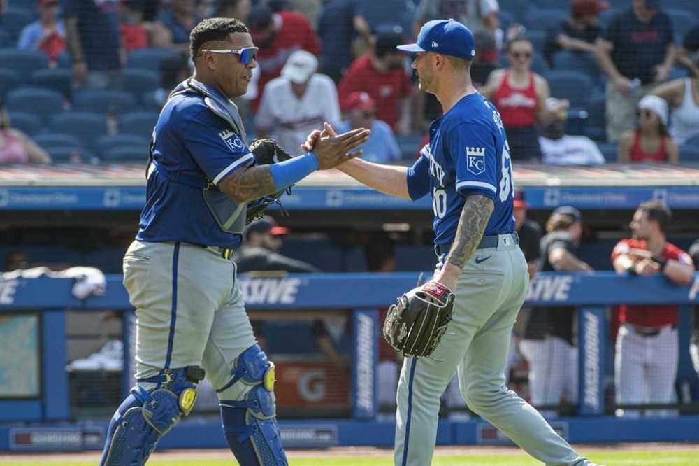 Kansas City Royals' Salvador Perez, left, congratulates Lucas Erceg, right, at the end of the first game of a baseball doubleheader against the Cleveland Guardians in Cleveland, Monday, Aug. 26, 2024. (AP Photo/Phil Long)