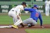Chicago Cubs' Ian Happ, right, steals second ahead of the tag by Pittsburgh Pirates second baseman Nick Gonzales, left, during the first inning of a baseball game Monday, Aug. 26, 2024, in Pittsburgh. (AP Photo/Matt Freed)