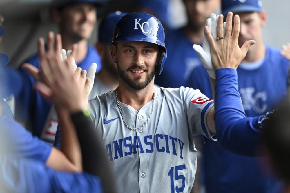 Kansas City Royals' Paul DeJong celebrates with teammates after hitting a solo home run during the second inning of the second game of a baseball doubleheader against the Cleveland Guardians, Monday, Aug. 26, 2024, in Cleveland. (AP Photo/Nick Cammett)