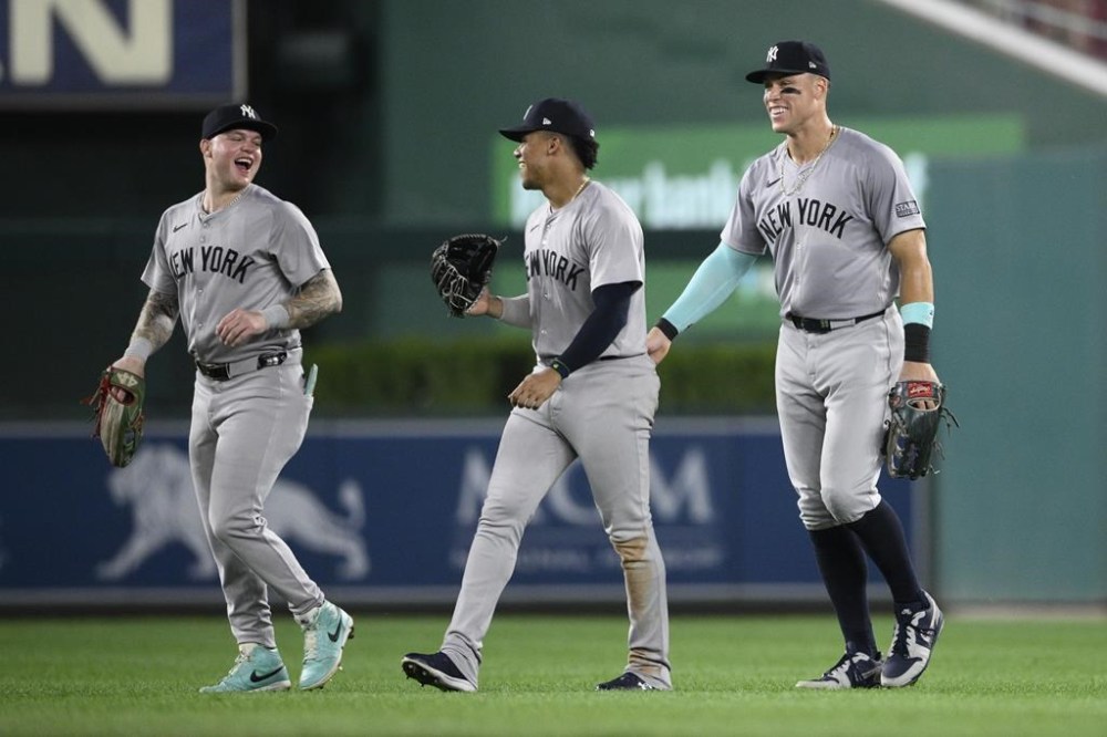 New York Yankees' Alex Verdugo, left, Juan Soto, center, and Aaron Judge, right, celebrate after a baseball game against the Washington Nationals, Monday, Aug. 26, 2024, in Washington. (AP Photo/Nick Wass)