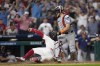 Philadelphia Phillies' Kyle Schwarber, left, scores the game-winning run past Houston Astros catcher Yainer Diaz on an RBI-single by Bryce Harper during the 10th inning of a baseball game, Monday, Aug. 26, 2024, in Philadelphia. (AP Photo/Matt Slocum)