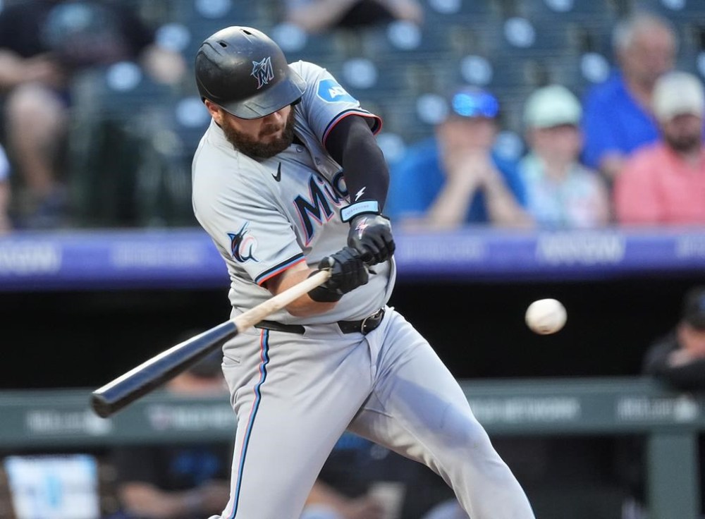 Miami Marlins' Jake Burger flies out against Colorado Rockies starting pitcher Ryan Feltner in the first inning of a baseball game Monday, Aug. 26, 2024, in Denver. (AP Photo/David Zalubowski)