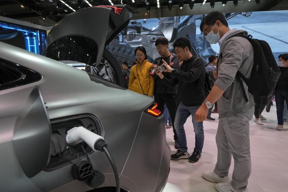 FILE - Visitors look at a Geely Galaxy E8 EV car model during the Auto China 2024 in Beijing on April 28, 2024. (AP Photo/Andy Wong, File)