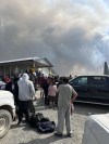 Residents of the Bunibonibee Cree Nation in Oxford House, Man. prepare to evacuate due to a nearby wildfire in an Aug. 13, 2024 handout photo. The Canadian Red Cross says it's supporting more than 2,300 people from the First Nation. THE CANADIAN PRESS/HO — Richard Hart *MANDATORY CREDIT*
