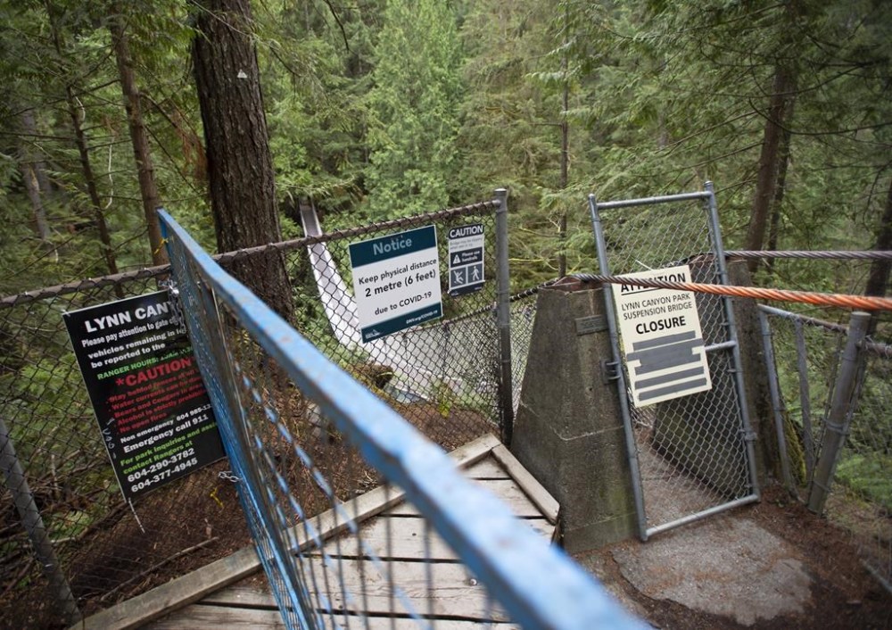 A 17-year-old from Ontario is dead after climbing over a fence and falling off the edge of a cliff in a popular park in North Vancouver, B.C. Fences block the access to the Lynn Suspension Bridge in North Vancouver, B.C., Monday, Sept. 21, 2020. THE CANADIAN PRESS/Jonathan Hayward