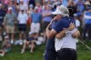 Keegan Bradley, left, embraces his father Mark Bradley after winning the BMW Championship golf event at Castle Pines Golf Club, Sunday, Aug. 25, 2024, in Castle Rock, Colo. (AP Photo/Matt York)