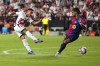 Rayo's Alvaro Garcia, left, kicks the ball ahead of Barcelona's Ferran Torres during the Spanish La Liga soccer match between Rayo Vallecano and Barcelona at the Vallecas stadium in Madrid, Spain, Tuesday, Aug. 27, 2024. (AP Photo/Manu Fernandez)