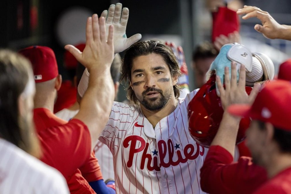 Philadelphia Phillies' Nick Castellanos is cheered in the dugout after hitting a three run homer in the third inning of a baseball game against the Houston Astros, Tuesday, Aug. 27, 2024, in Philadelphia. (AP Photo/Laurence Kesterson)