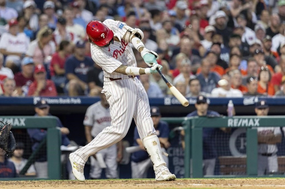 Philadelphia Phillies' Nick Castellanos hits a three run homer in the third inning of a baseball game against the Houston Astros, Tuesday, Aug. 27, 2024, in Philadelphia. (AP Photo/Laurence Kesterson)