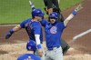 Chicago Cubs' Dansby Swanson, right, celebrates with Nico Hoerner, left, as he returns to the dugout after hitting a two-run home run off Pittsburgh Pirates starting pitch Jared Jones during the fourth inning of a baseball game in Pittsburgh, Tuesday, Aug. 27, 2024. (AP Photo/Gene J. Puskar)