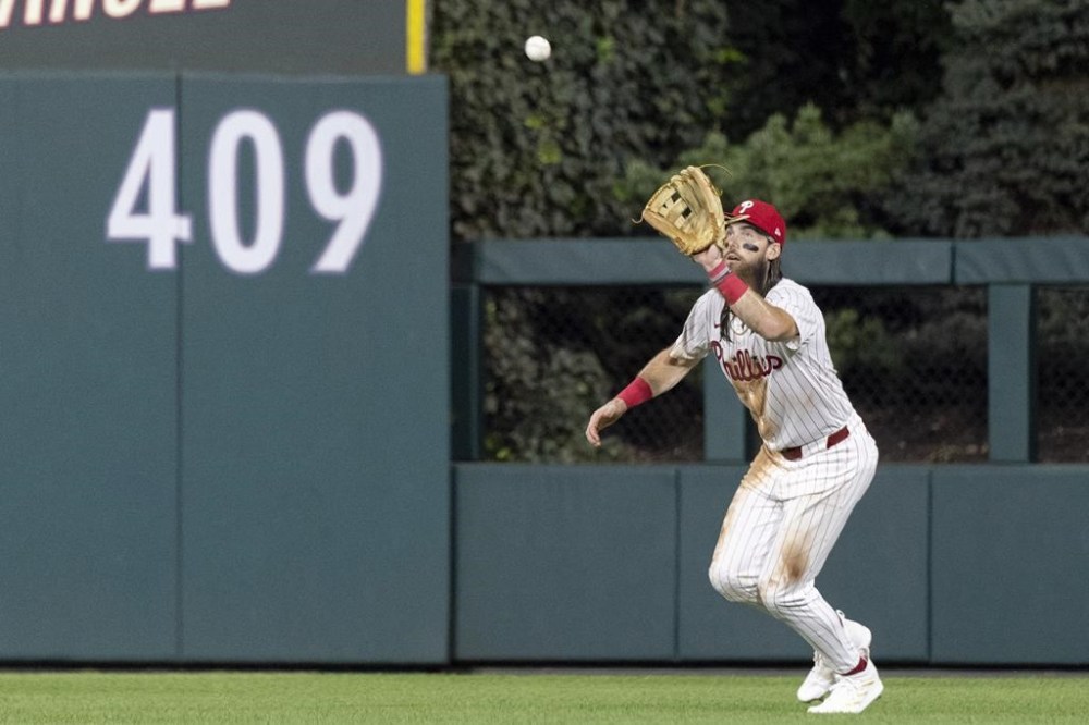Philadelphia Phillies outfielder Brandon Marsh catches a fly from Houston Astros Mauricio Dubón in the fifth inning of a baseball game, Tuesday, Aug. 27, 2024, in Philadelphia. (AP Photo/Laurence Kesterson)