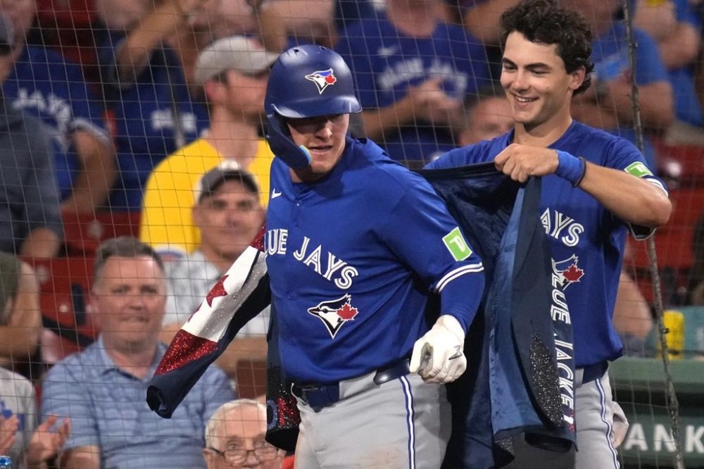 Toronto Blue Jays' Will Wagner is congratulated by Joey Loperfido, right, after hitting a solo home run during the sixth inning of a baseball game against the Boston Red Sox at Fenway Park, Tuesday, Aug. 27, 2024, in Boston. (AP Photo/Charles Krupa)