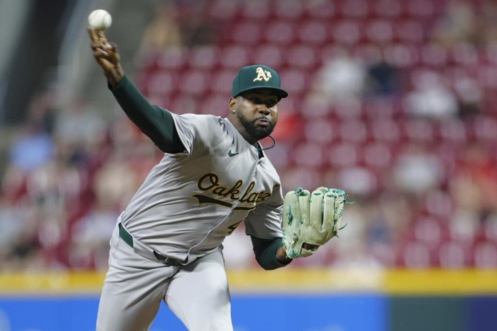 Oakland Athletics relief pitcher Michel Otanez throws against the Cincinnati Reds during the sixth inning of a baseball game, Tuesday, Aug. 27, 2024, in Cincinnati. (AP Photo/Jay LaPrete)