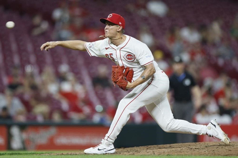 Cincinnati Reds relief pitcher Casey Legumina throws against the Oakland Athletics during the eighth inning of a baseball game, Tuesday, Aug. 27, 2024, in Cincinnati. (AP Photo/Jay LaPrete)