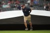 The Cleveland Guardians grounds crew brings out the tarp for a rain delay after the fifth inning of a baseball game between the Kansas City Royals and the Cleveland Guardians Tuesday, Aug. 27, 2024, in Cleveland. (AP Photo/Sue Ogrocki)