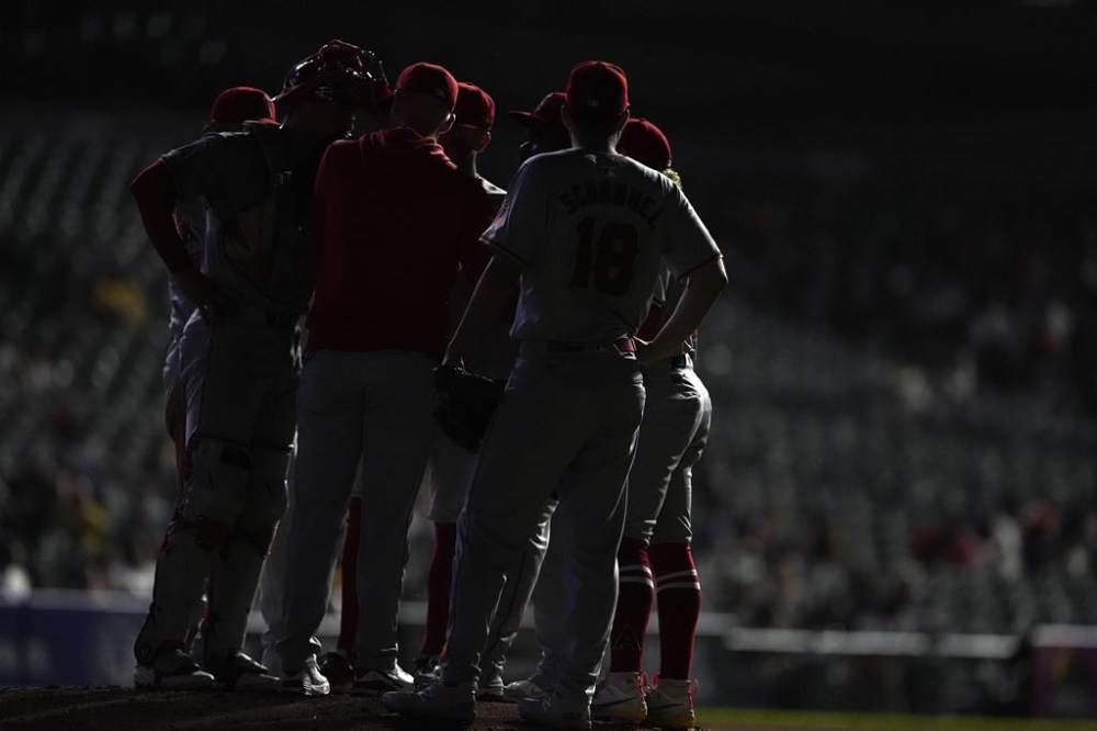 Los Angeles Angels pitching coach Barry Enright visits starting pitcher Johnny Cueto on the mound during the fourth inning of a baseball game against the Detroit Tigers, Tuesday, Aug. 27, 2024, in Detroit. (AP Photo/Carlos Osorio)