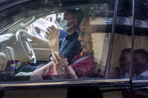 Tibetan spiritual leader the Dalai Lama greets a welcoming crowd from inside his car as he arrives in Dharamshala, India, Wednesday, Aug. 28, 2024. (AP Photo/Ashwini Bhatia)