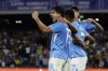 Napoli's Giovanni Simeone, left, celebrates after scoring his team's third goal during the Serie A soccer match between Napoli and Bologna at the Diego Armando Maradona Stadium in Naples, Italy, Sunday, Aug. 25, 2024. (Alessandro Garofalo/LaPresse via AP)