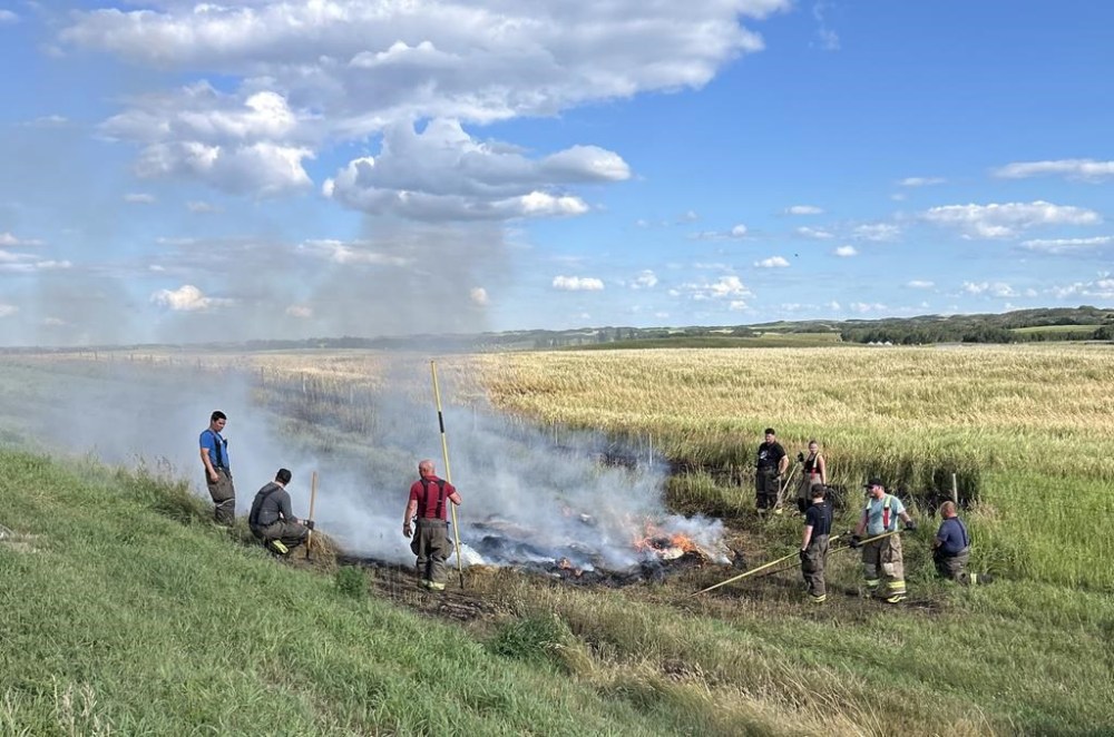 Crews snuff out hay bales on fire near Macklin, Sask., July 30. A Saskatchewan man faces arson charges for allegedly setting hay bales on fire around a town in the province's west-central region.THE CANADIAN PRESS/HO - Justin Bast *MANDATORY CREDIT*