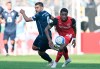 Leverkusen's Jeanuel Belocian, right, and Jena's Cemal Sezer challenge for the ball during the German Cup 1st round soccer match between FC Carl Zeiss Jena and Bayer 04 Leverkusen at the Ernst-Abbe-Sportfeld in Jena, Germany, Wednesday, Aug. 28, 2024. (Hendrik Schmidt/dpa via AP)