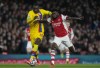 FILE - Crystal Palace's Christian Benteke, left, challenges for the ball with Arsenal's Thomas Partey during an English Premier League soccer match between Arsenal and Crystal Palace at the Emirates Stadium in London, England, Oct. 18, 2021. (AP Photo/Alastair Grant, File)