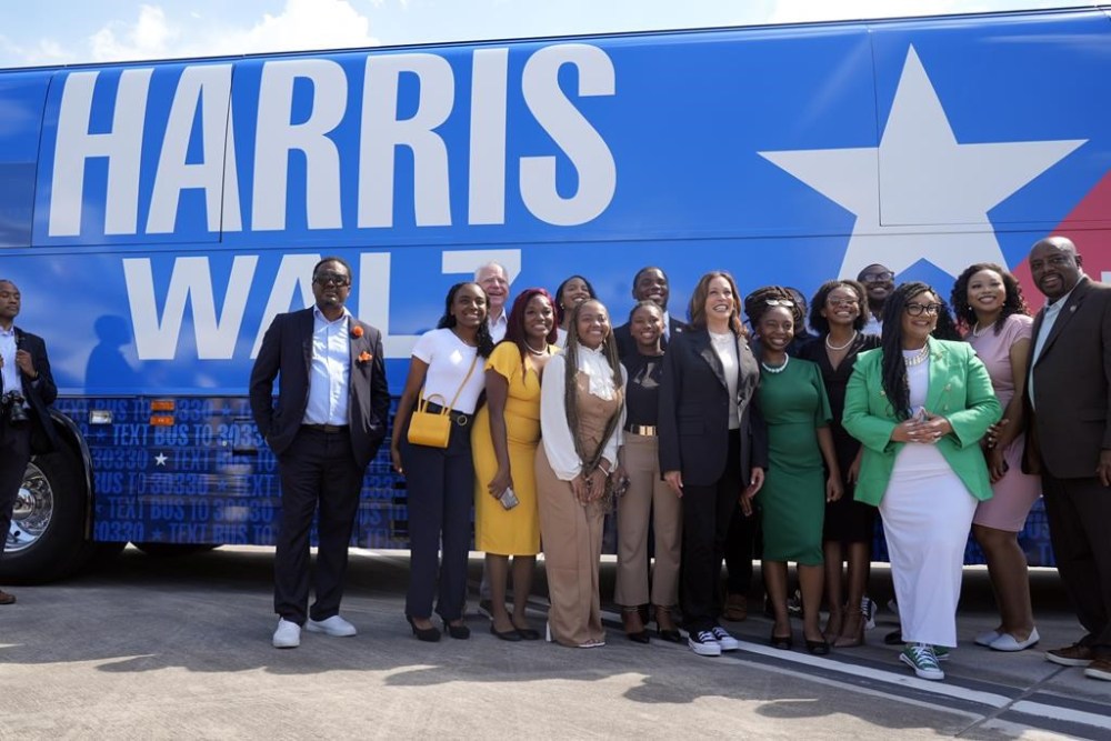 Democratic presidential nominee Vice President Kamala Harris pose for a photo with supporters at the Savannah/Hilton Head International Airport in Savannah, Ga., as before campaign events, Tuesday, Aug. 28, 2024. (AP Photo/Jacquelyn Martin)