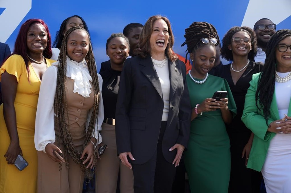 Democratic presidential nominee Vice President Kamala Harris pose for a photo with supporters at the Savannah/Hilton Head International Airport in Savannah, Ga., as before campaign events, Tuesday, Aug. 28, 2024. (AP Photo/Jacquelyn Martin)